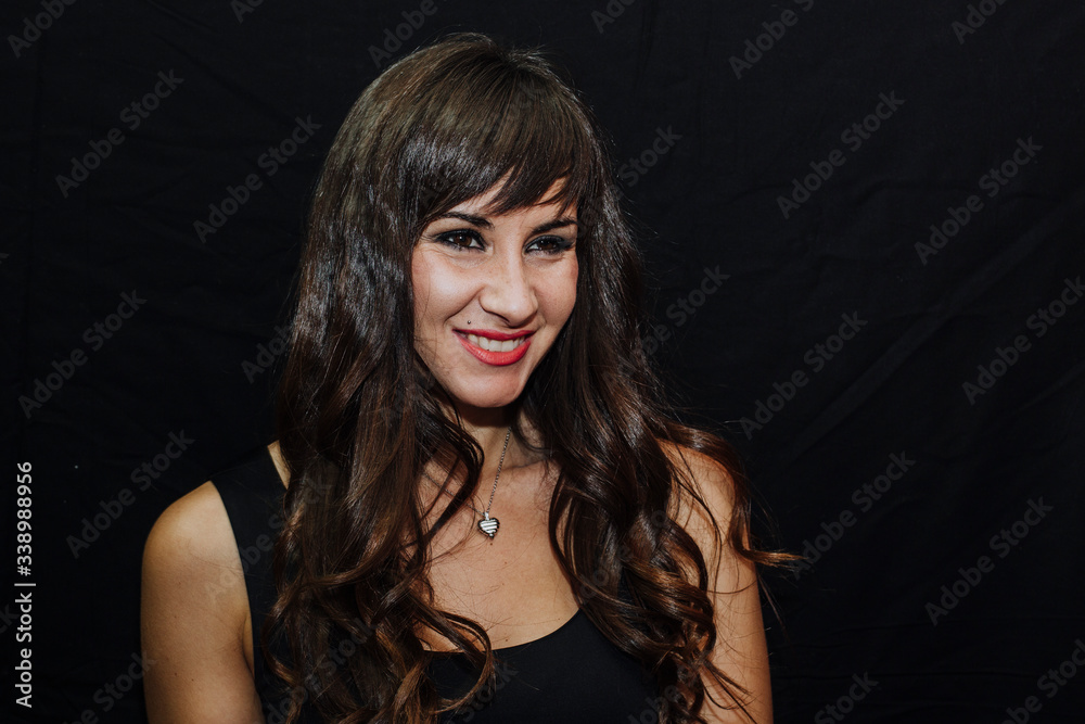 Long-haired brunette woman on black background