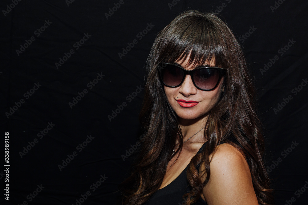 Long-haired brunette woman on black background Long-haired brunette woman on black background