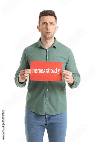 Young man holding paper wit...