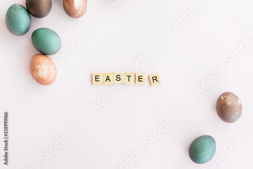 Photography Word EASTER written on Scrubble letters isolated on pink background