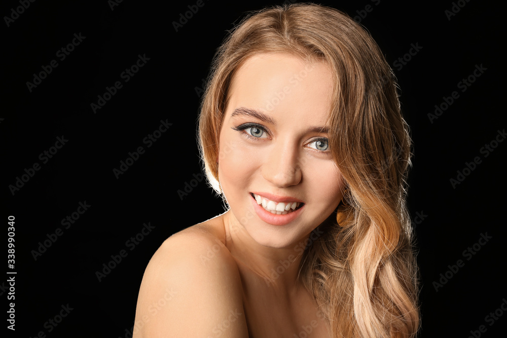 Young blonde with beautiful hair on dark background Young blonde with beautiful hair on dark background