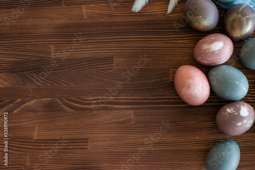 Happy easter egg. set of Holiday eggs on brown wooden backround, copy space. Natural colorful eggs painted in pastel colors , happy Easter concept.