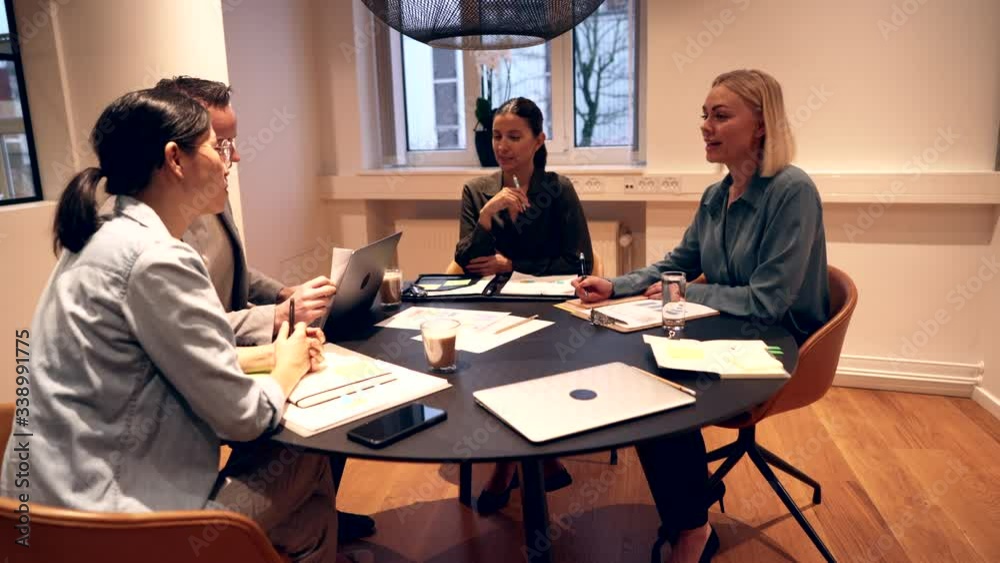 Diverse group of smiling
businesspeople having a
late office meeting Diverse group of smiling
businesspeople having a
late office meeting