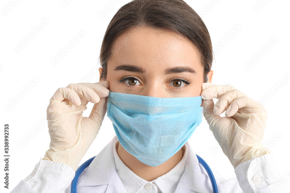 Doctor wearing medical mask against white background Doctor wearing medical mask against white background