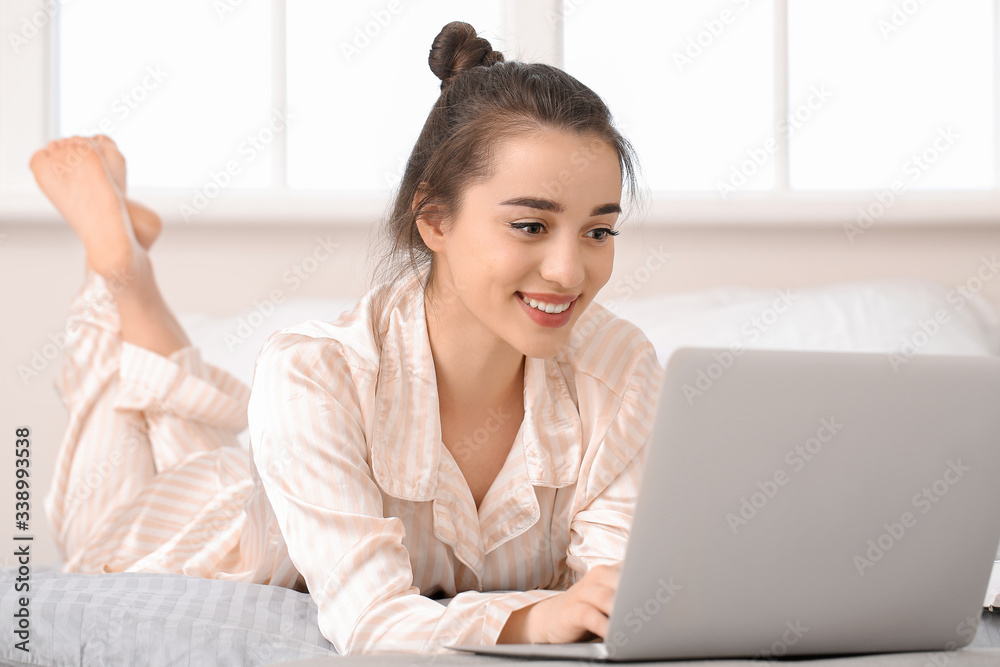 Beautiful young woman working on laptop at home Beautiful young woman working on laptop at home