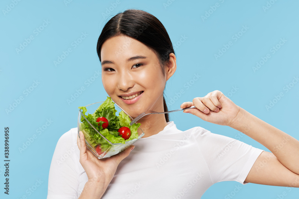 Cheerful woman of Asian appearance salad eating food diet vegetarianism Cheerful woman of Asian appearance salad eating food diet vegetarianism