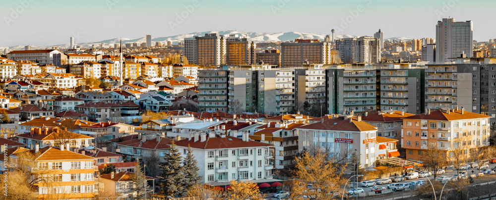 Panoramic view of City of Ankara, Turkey,  Buildings and a Snowy Mountain, Sunset