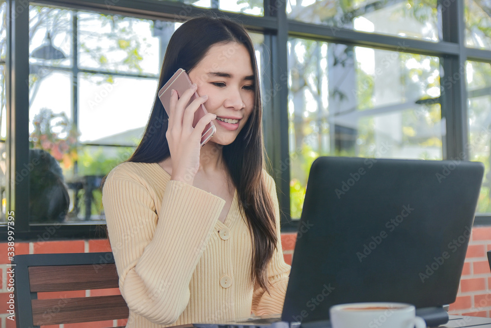 Asian women calling mobile phone business contract online technology work from home