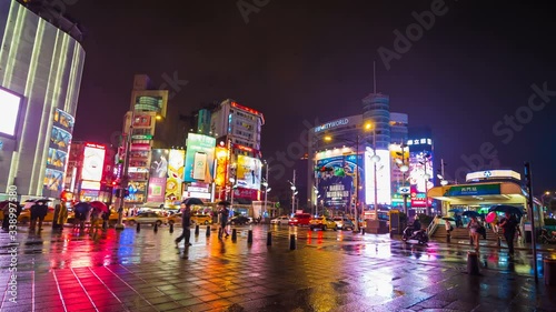 4k Time-lapse of Traffic on road with falling rain in Ximen district at night, Taipei, Taiwan