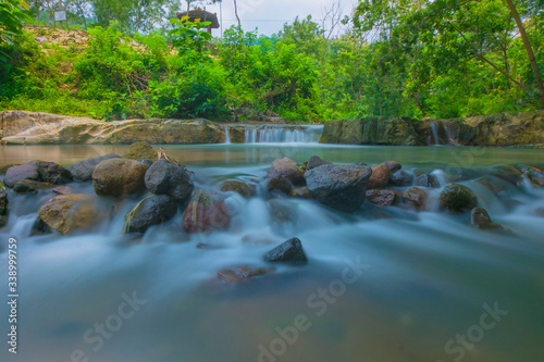 illustrastion photograph of fresh waterfall showing calmness perfect for lodging business like hotel,homestay etc photo