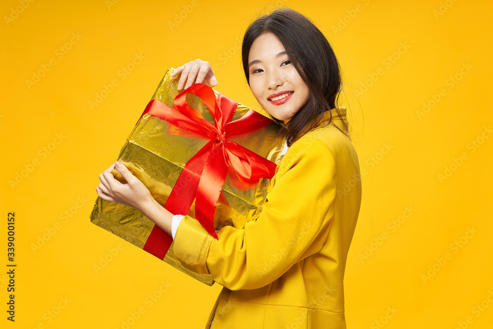 Cheerful woman gift holiday decoration yellow background Cheerful woman gift holiday decoration yellow background