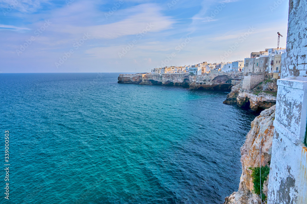 Houses on dramatic cliffs over Adriatic Sea On A Sunny Autumn Day At Polignano a Mare- Apulia - Italy