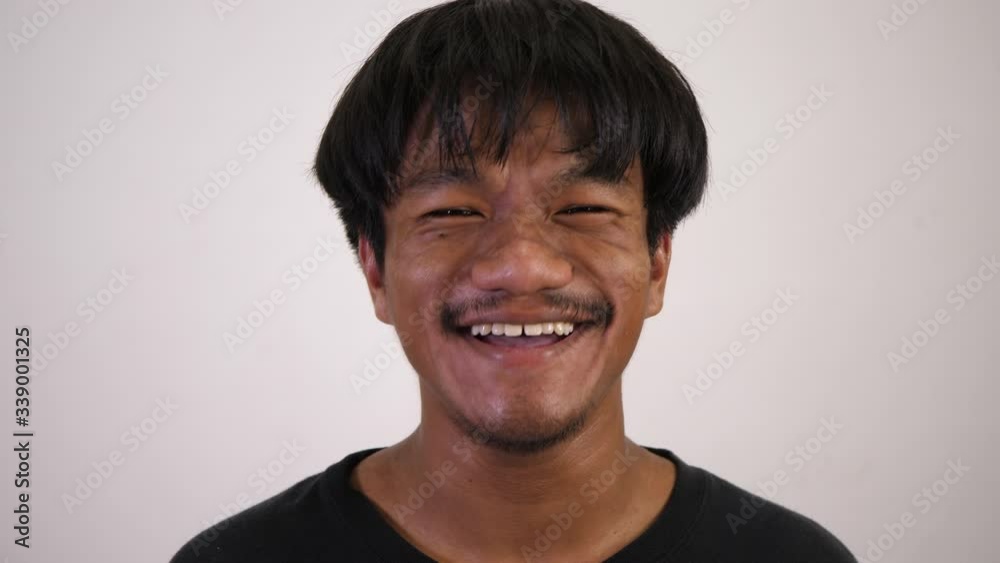 The asian boy smiles and looks happy with white background The asian boy smiles and looks happy with white background