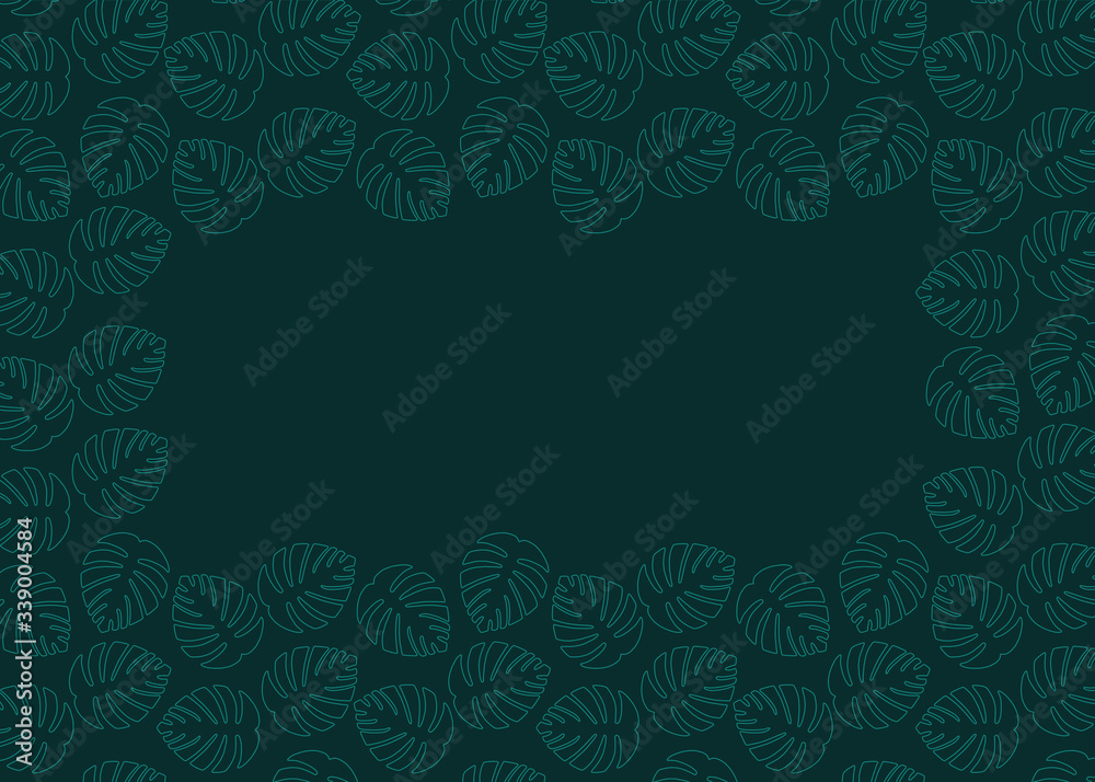 Monstera leaves on green background with copyspace.