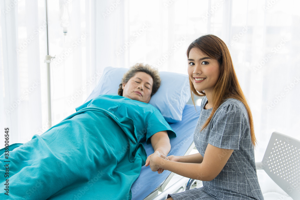 Asian family visit an elderly in a hospital Asian family visit an elderly in a hospital