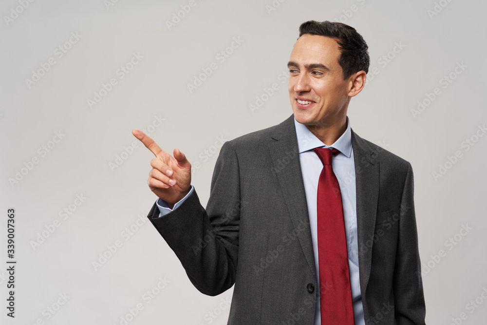 Business man points a finger to the side Business man points a finger to the side