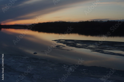 sunset over ice thaw on lake © timfromfargo