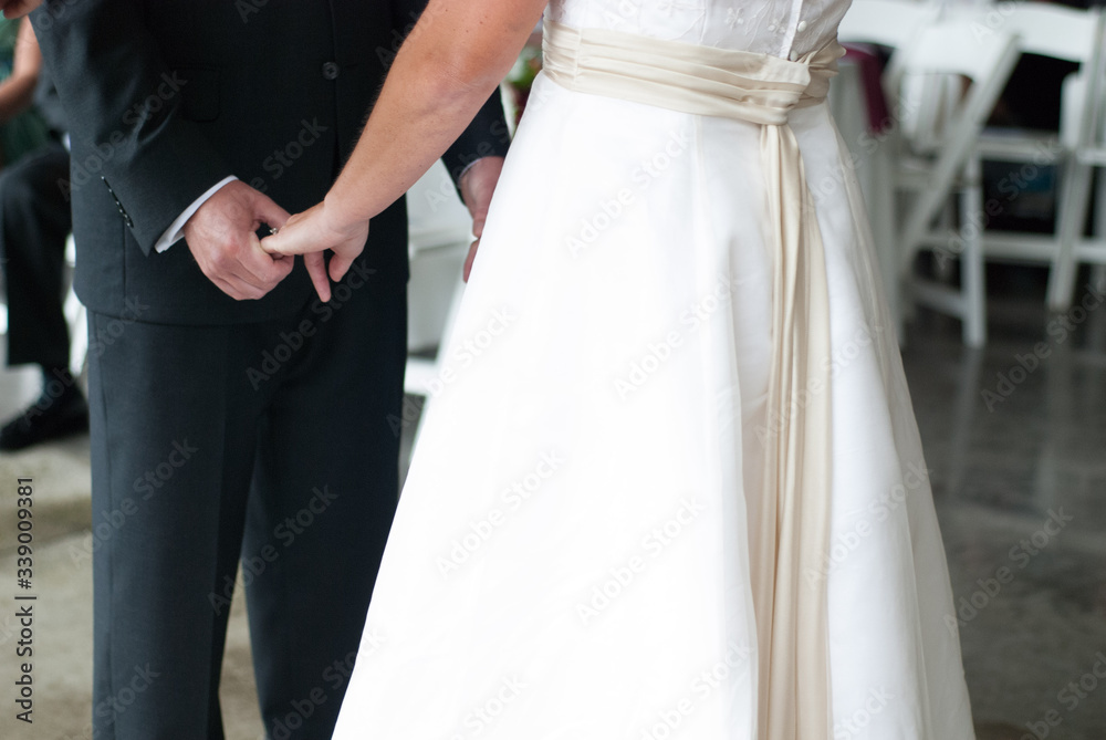 bride and groom holding hands