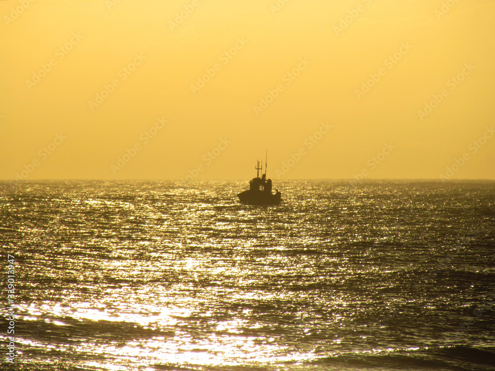 Fishing boat starting its work at dusk