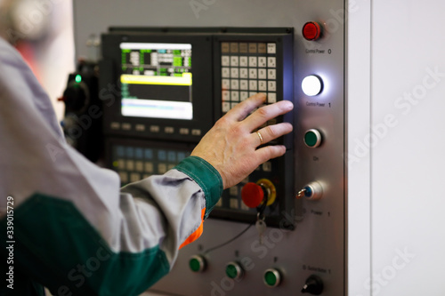 operator programs the CNC manufacturing machine