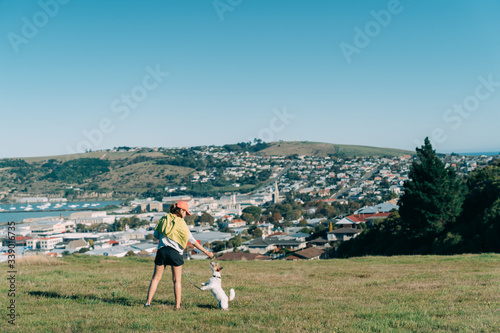 Young attractive walking with a dog in the park Oamaru, New Zealand.