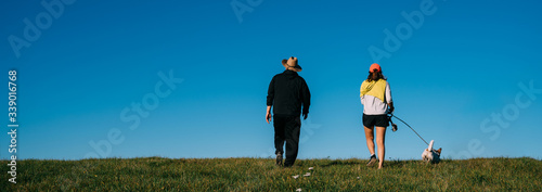 Young attractive walking with a dog in the park Oamaru, New Zealand.