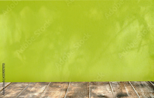 Fototapeta Naklejka Na Ścianę i Meble -  Old top table .Background is green wall blured  mockup background concept .