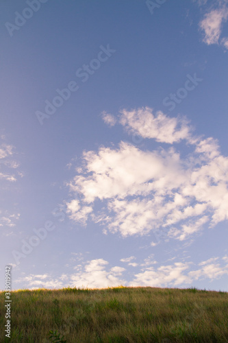 summer sky and high altocumulus  clouds landscape and plane horizon field of grass