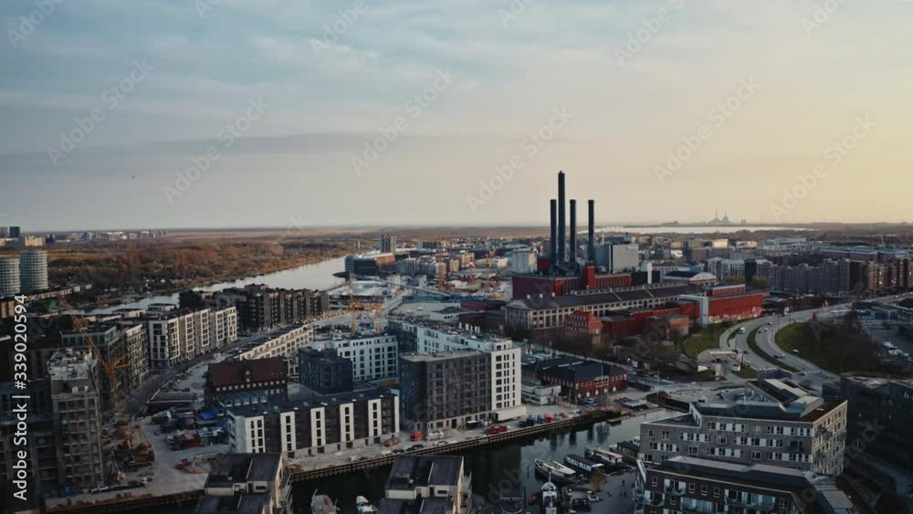 Epic view from Copenhagen canals and city with red building with chimneys in background at sunset from aerial view Epic view from Copenhagen canals and city with red building with chimneys in background at sunset from aerial view