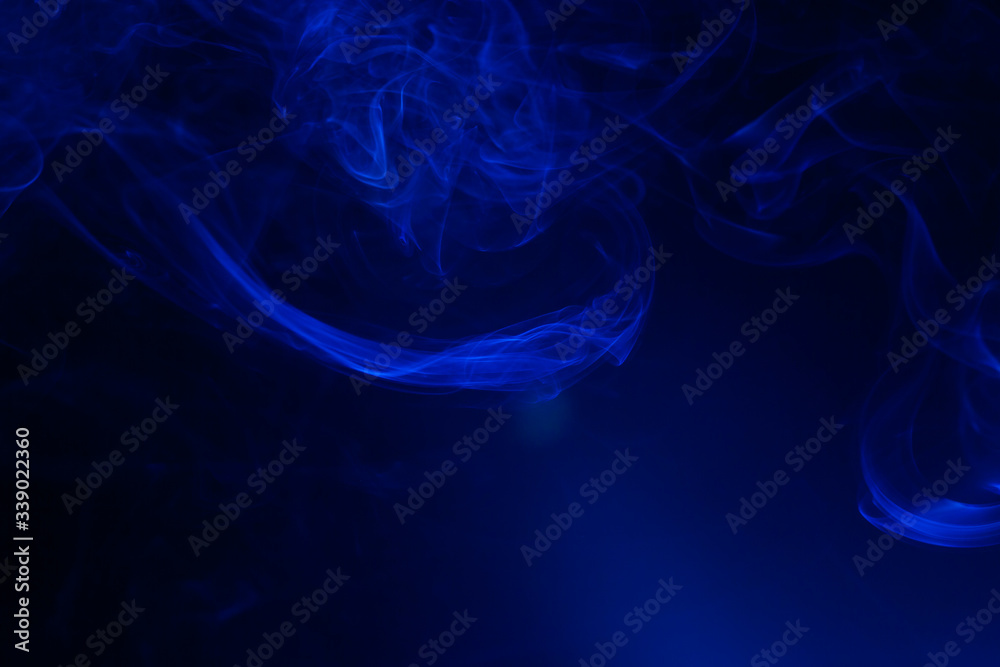 Blue smoke on black background.