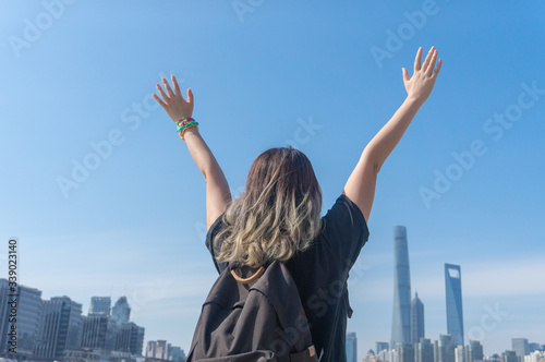 Photography Asian girl traveller with dyed hair raises her hands and waving hands looking fa
