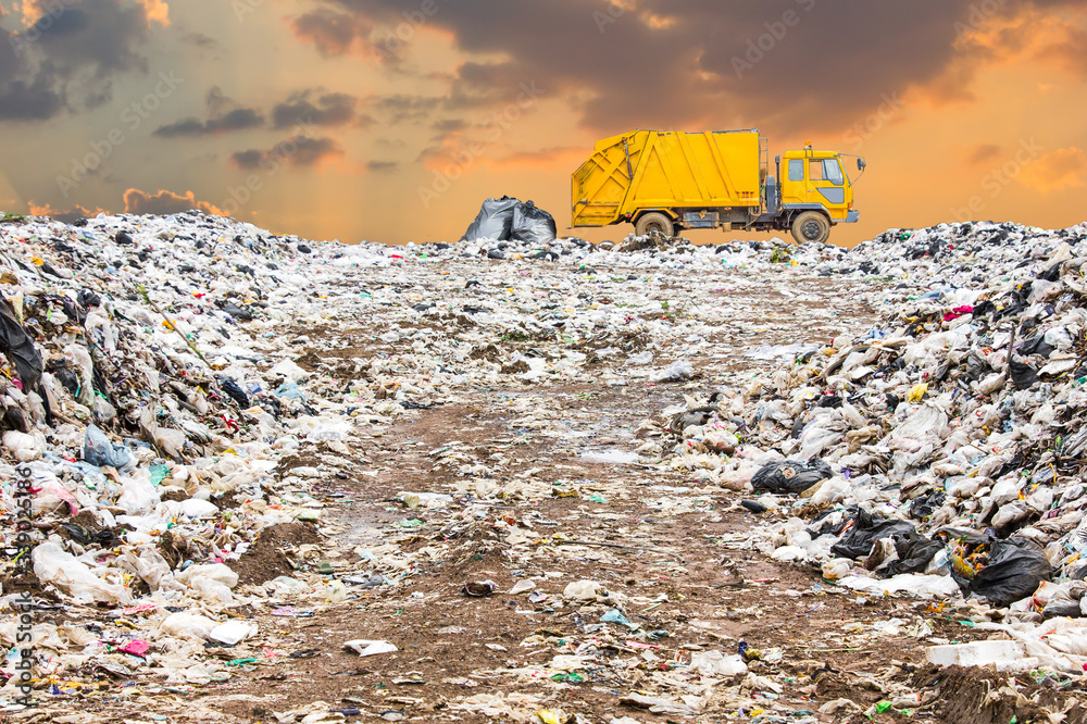 garbage dump pile in trash dump or landfill, truck is dumping the