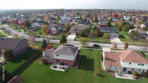 Overhead aerial view of colorful autumn trees residential houses and yards along suburban street - Travel and leisure concept