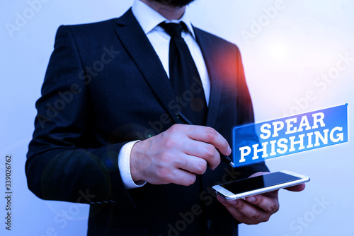 Text sign showing Spear Phishing. Business photo text Sending fake emails to extract financial data from user Male human wear formal work suit hold smart hi tech smartphone use one hand photo