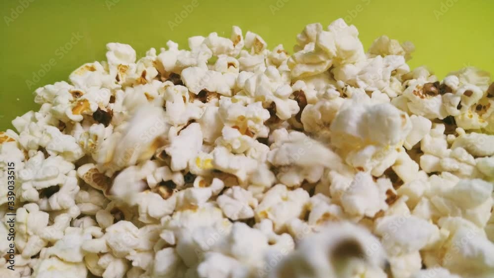 Airy salty popcorn. Tossing popcorn into a bowl. Snack for watching movies. 4K. Airy salty popcorn. Tossing popcorn into a bowl. Snack for watching movies. 4K.