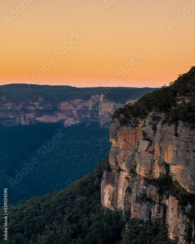 Golden sunrise across orange sandstone cliffs above eucalyptus trees in the Gross Valley in the Blue Mountains, west of Sydney, Australia © Andrew Atkinson