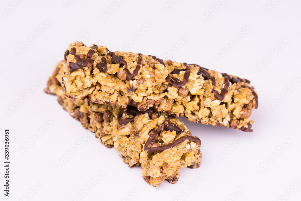
Granola Bars with Chocolate on White Background. Healthy Sweet Snack. Close-up.