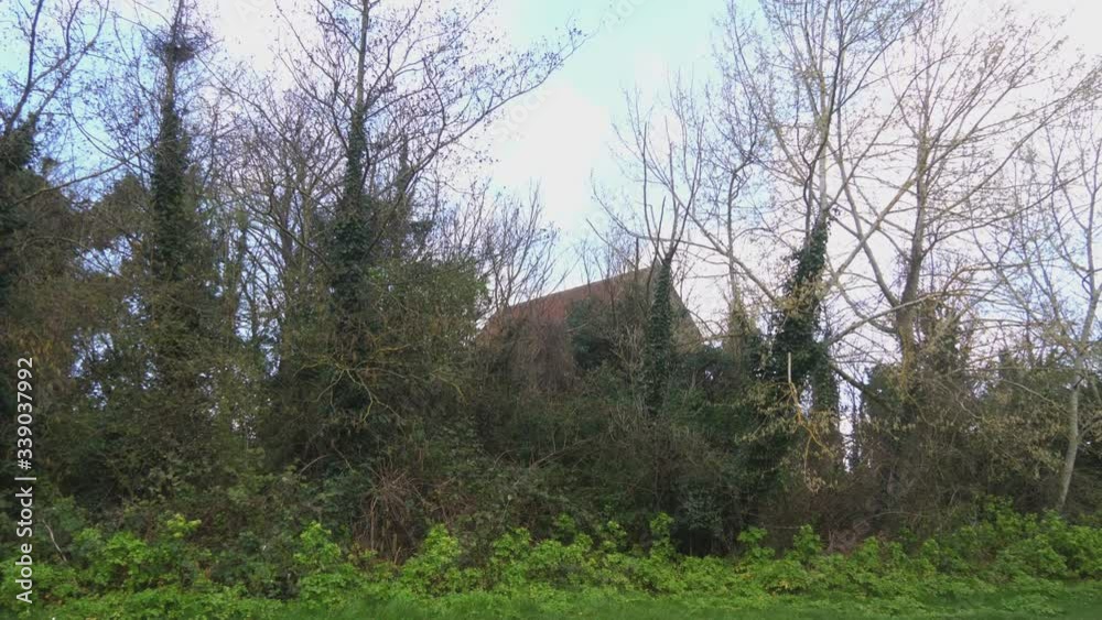 The roof of the Stone Church is visible behind the trees The roof of the Stone Church is visible behind the trees