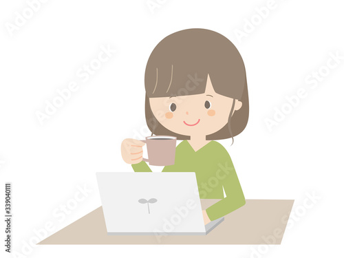 Woman drinking coffee while looking at the computer.