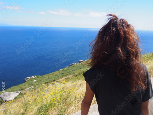 A woman's back and the sea, Camino de Santiago, Way of St. James, Journey from Muxia to Fisterra, Fisterra-Muxia way, Spain