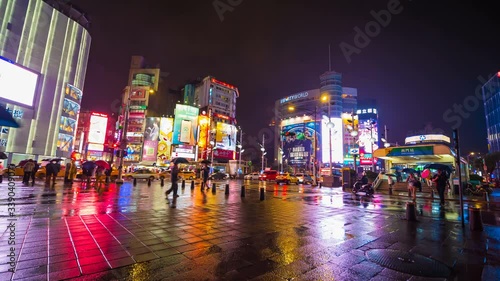 4k Time-lapse of Traffic on road with falling rain in Ximen district at night, Taipei, Taiwan