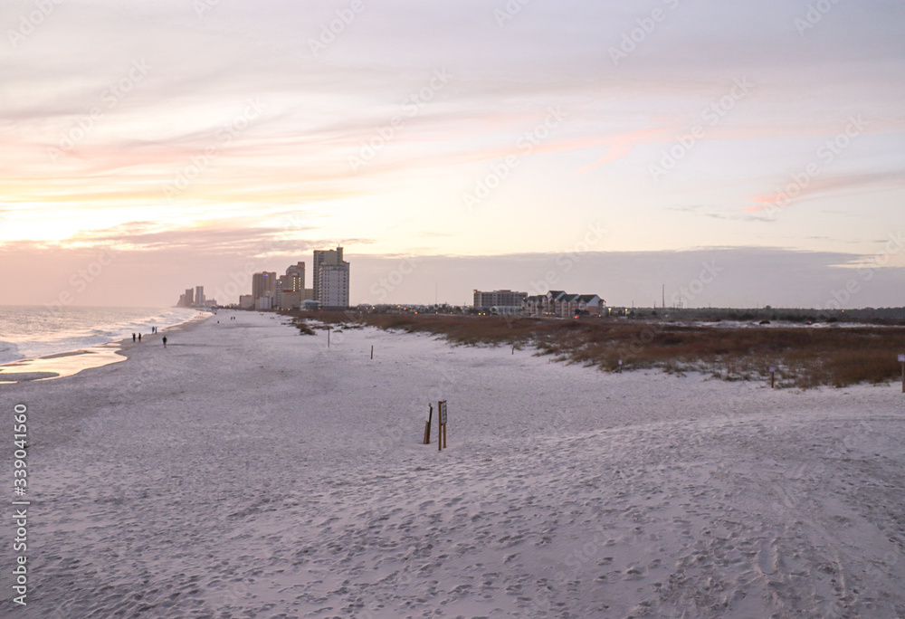 sunset over beach with distant condos