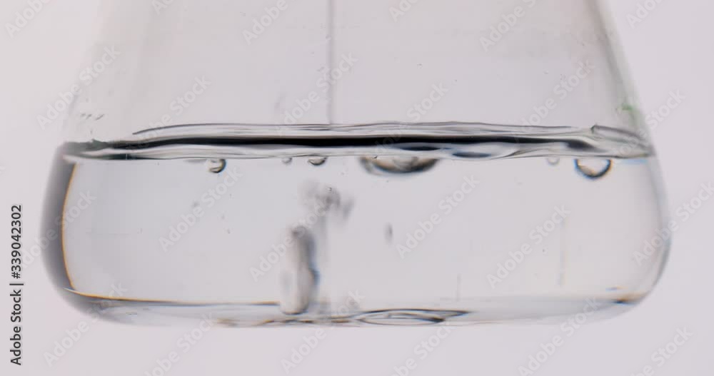 Close-up shooting. the flask is Filling with a clear fluid. Experiments in the laboratory. Search for a vaccine. 4K Close-up shooting. the flask is Filling with a clear fluid. Experiments in the laboratory. Search for a vaccine. 4K