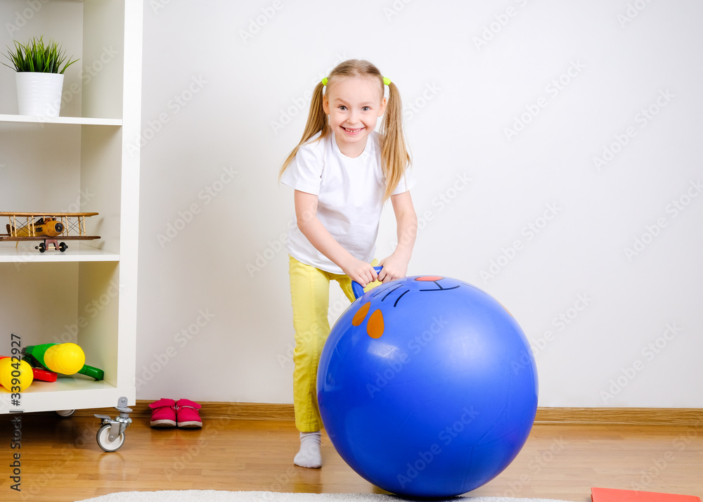 The child plays with the ball. Girl jumping on a big ball The child plays with the ball. Girl jumping on a big ball