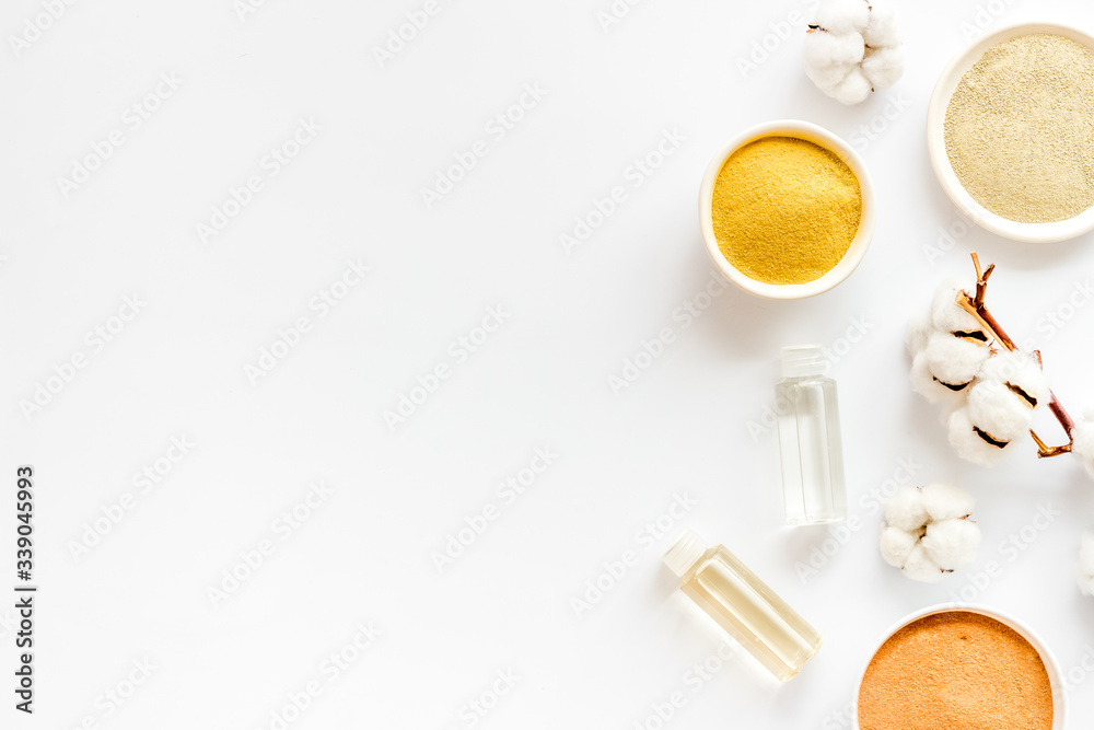 Set of cosmetic clays for facial beauty face mask on white table top-down frame space for text Set of cosmetic clays for facial beauty face mask on white table top-down frame space for text