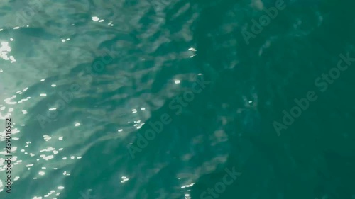 Wallpaper Mural Aerial top down view from high altitude of green sea water texture. The camera flies over the water, a view of the water surface. Background of the water surface. 4K aerial view Torontodigital.ca