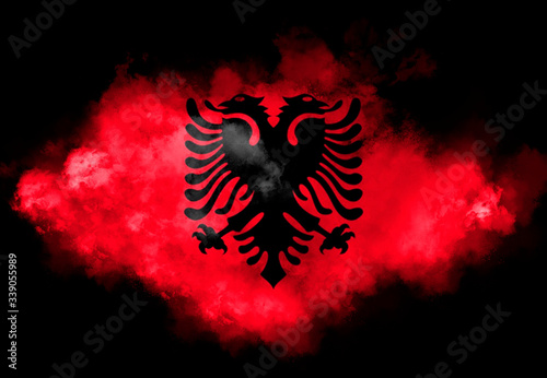 Albanian flag performed from color smoke on the black background. Abstract symbol.