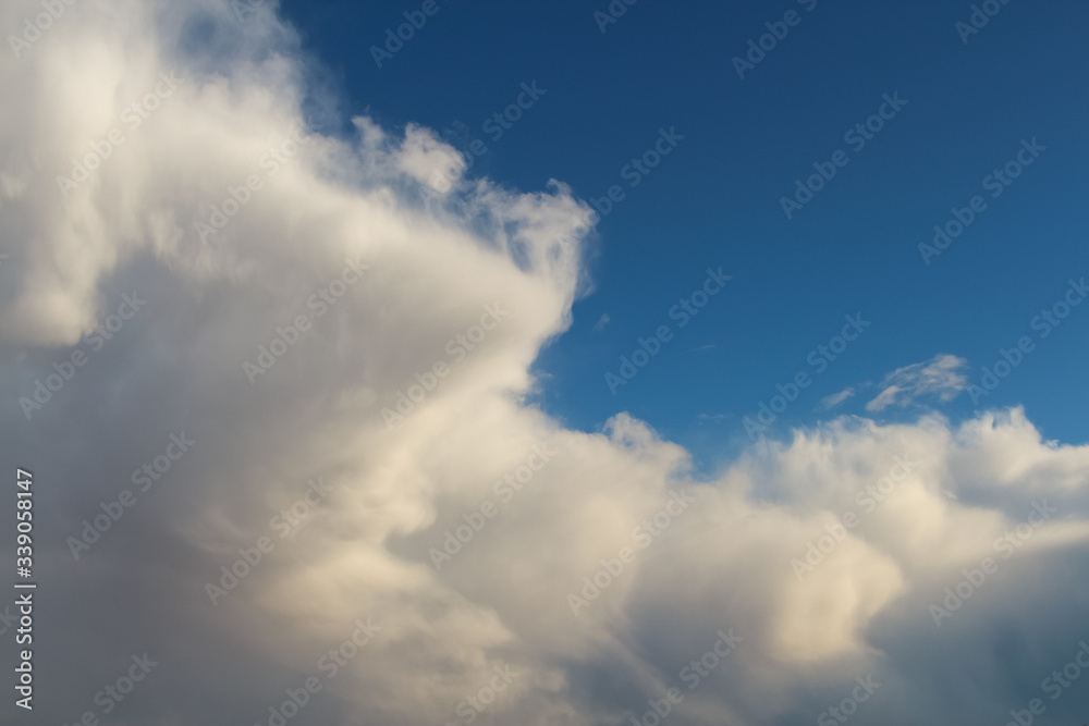 Large Cumulus mediocris cloud on the blue sky during sunset. Theme of beautiful landscapes.
