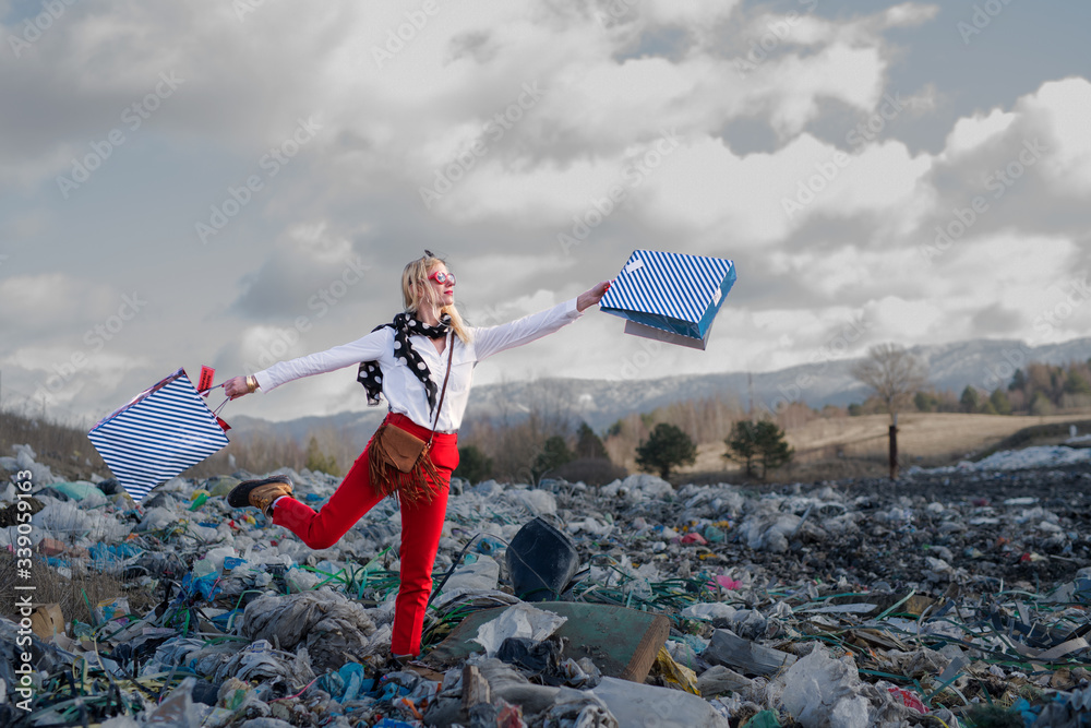 Modern woman on landfill, consumerism versus pollution concept. - obrazy, fototapety, plakaty 