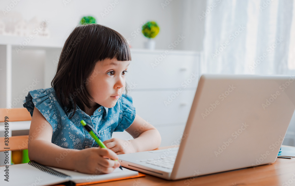 Distance learning online education. A schoolboy boy studies at home and does school homework. A home distance learning Distance learning online education. A schoolboy boy studies at home and does school homework. A home distance learning